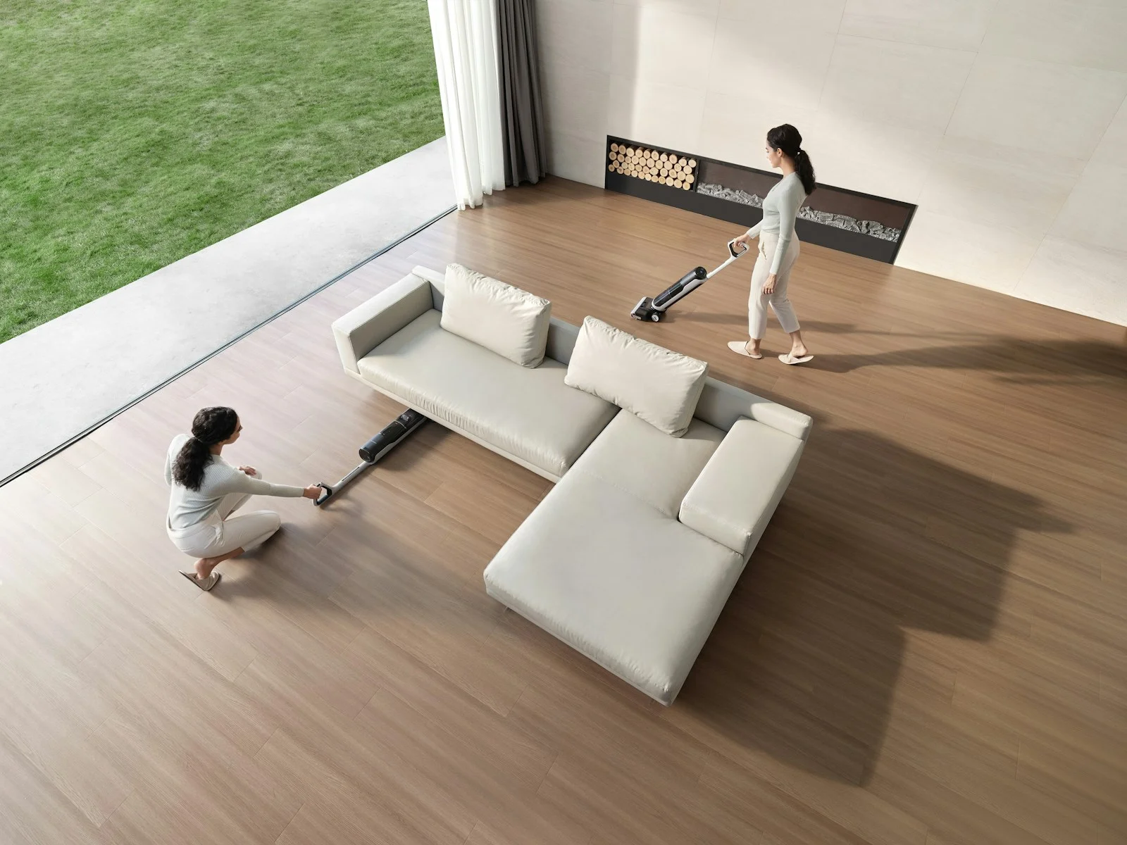 Two people caring for the floors in a spacious, sunlit living room