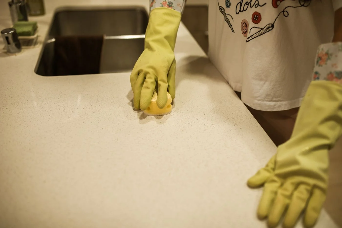 Hands cleaning a kitchen counter
